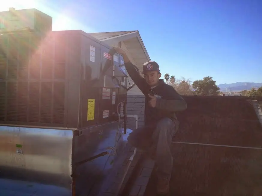 HVAC technician performing AC Tune-Up on a rooftop unit in Union Grove
